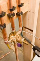 Plumber performing a copper repipe for an addition